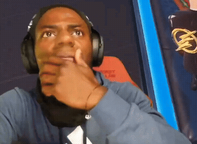 A Man Wearing Headphones And A Blue Shirt With A White Triangle On It GIF