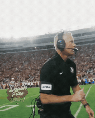 A Man Wearing Headphones And A Double Fries Sign On The Field GIF