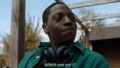 A Man Wearing Headphones And A Green Shirt Is Asking Which One Am I GIF