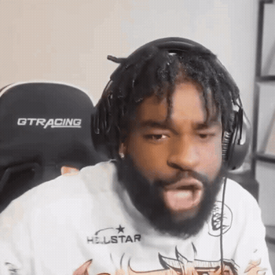 A Man Wearing Headphones And A Gtracing Chair GIF