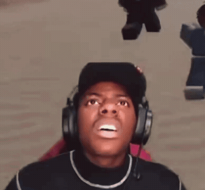 A Man Wearing Headphones And A Hat Is Making A Face . GIF