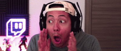 A Man Wearing Headphones And A Hat Is Making A Funny Face . GIF