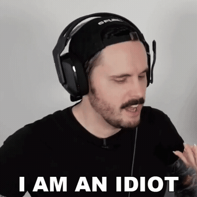 A Man Wearing Headphones And A Hat Is Saying " I Am An Idiot " GIF