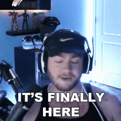 A Man Wearing Headphones And A Hat Is Saying It 'S Finally Here GIF