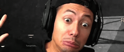 A Man Wearing Headphones And A Hat Making A Funny Face . GIF