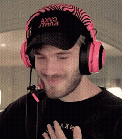 A Man Wearing Headphones And A Hat That Says Akv On It . GIF