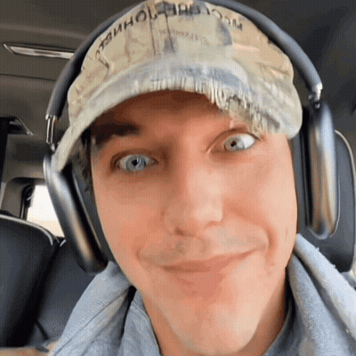 A Man Wearing Headphones And A Hat That Says " Washington " On It GIF