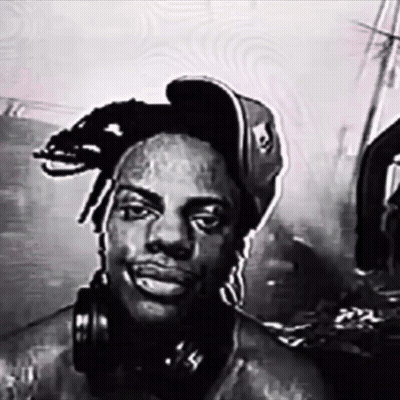 a man wearing headphones and a hat with a skull on it