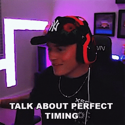 A Man Wearing Headphones And A Hat With Ny On It Says Talk About Perfect Timing GIF
