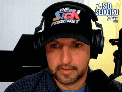 A Man Wearing Headphones And A Hat With The Sick Podcast Written On It GIF