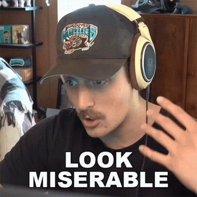 A Man Wearing Headphones And A Hat With The Words Look Miserable GIF