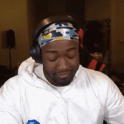 a man wearing headphones and a headband is looking at the camera