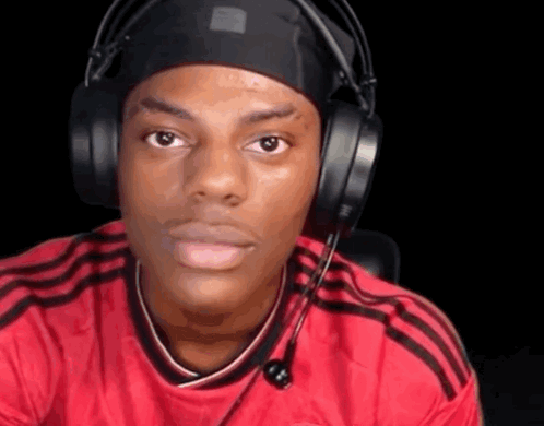 A Man Wearing Headphones And A Headband Is Making A Face . GIF