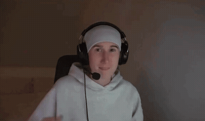 A Man Wearing Headphones And A Headband Is Reaching Out With His Hand GIF