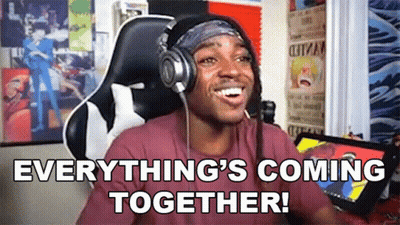 A Man Wearing Headphones And A Headband Is Sitting In A Chair And Smiling . GIF