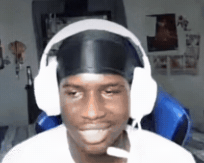 A Man Wearing Headphones And A Headband Is Sitting In A Chair And Smiling . GIF
