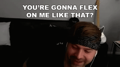 A Man Wearing Headphones And A Headband Is Sitting On A Couch And Talking To Someone . GIF