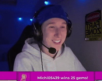 A Man Wearing Headphones And A Headband Is Smiling With The Words Michi05439 Wins 25 Gems Below Him GIF