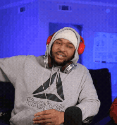 A Man Wearing Headphones And A Hoodie That Says Reebok GIF