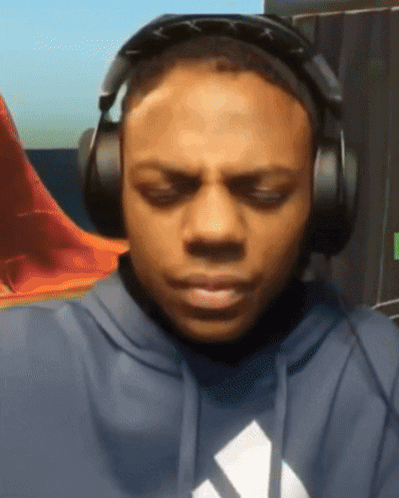A Man Wearing Headphones And A Hoodie With An Adidas Logo GIF