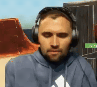 A Man Wearing Headphones And A Hoodie With An Adidas Logo On It GIF