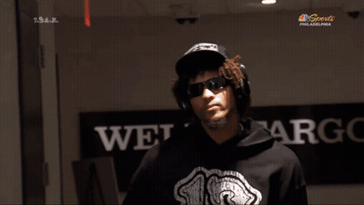 A Man Wearing Headphones And A Hoodie With The Number 18 On It GIF