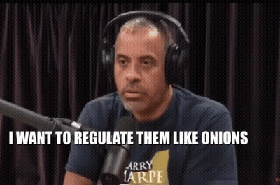 A Man Wearing Headphones And A Larry Tarpe Shirt Is Talking Into A Microphone GIF