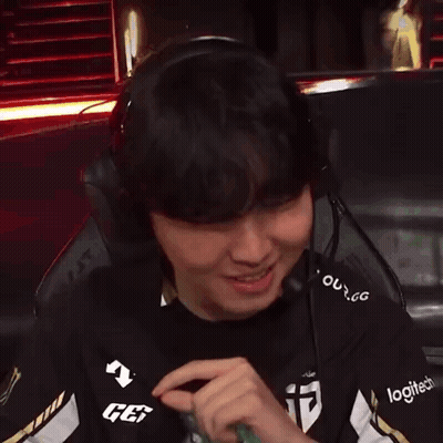 A Man Wearing Headphones And A Logitech Shirt Is Smiling GIF