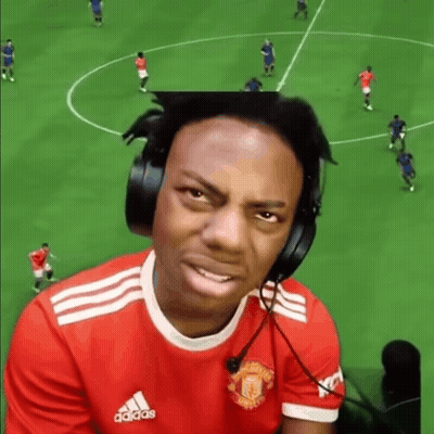 A Man Wearing Headphones And A Manchester United Shirt Is Playing A Video Game . GIF