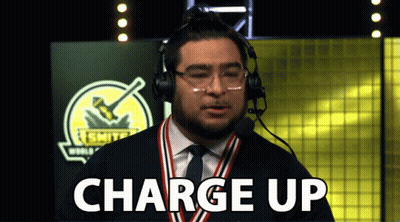 A Man Wearing Headphones And A Medal Around His Neck Is Saying Charge Up GIF