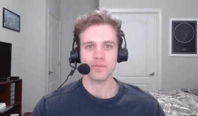 A Man Wearing Headphones And A Microphone In A Room GIF