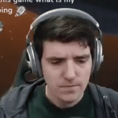A Man Wearing Headphones And A Microphone Is Looking Down . GIF