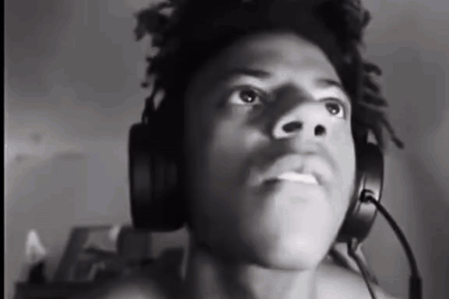 A Man Wearing Headphones And A Microphone Is Looking Up . GIF
