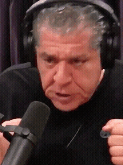 A Man Wearing Headphones And A Microphone Is Making A Funny Face . GIF