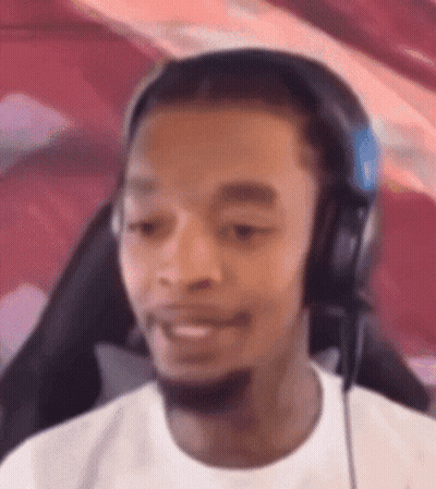 A Man Wearing Headphones And A Microphone Is Sitting In A Chair . GIF