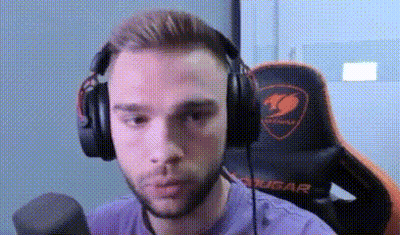 A Man Wearing Headphones And A Microphone Is Sitting In A Gaming Chair . GIF