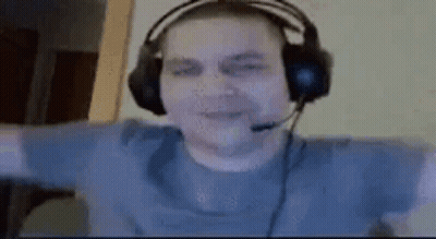A Man Wearing Headphones And A Microphone Is Sitting In Front Of A Computer . GIF