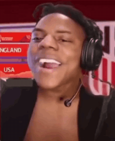 A Man Wearing Headphones And A Microphone Is Smiling . GIF