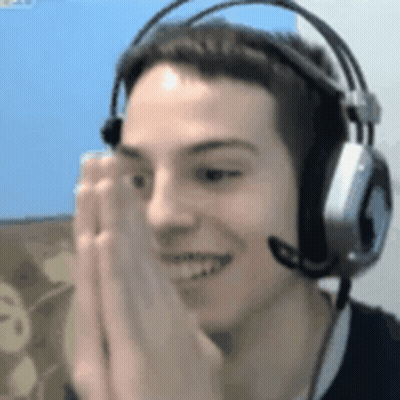 A Man Wearing Headphones And A Microphone Is Smiling And Making A Face . GIF