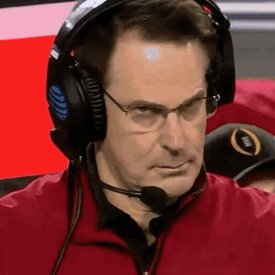 A Man Wearing Headphones And A Microphone Looks At The Camera . GIF