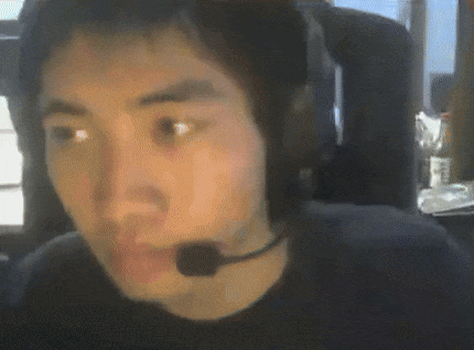 A Man Wearing Headphones And A Microphone Looks At The Camera . GIF