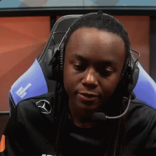 A Man Wearing Headphones And A Microphone Looks Down At Something GIF