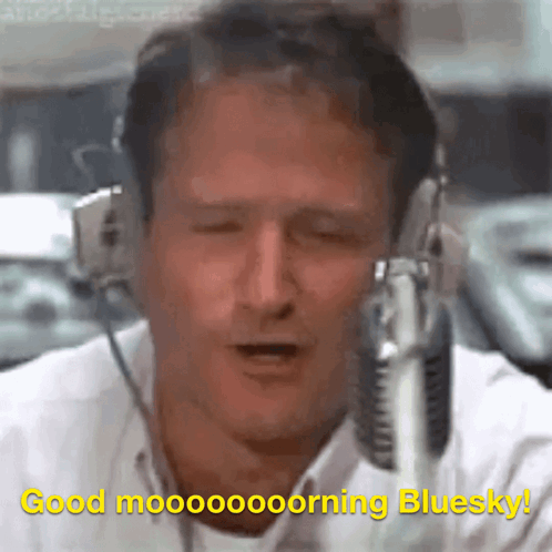 A Man Wearing Headphones And A Microphone Says Good Morning Bluesky GIF
