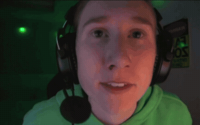 A Man Wearing Headphones And A Microphone Smiles GIF