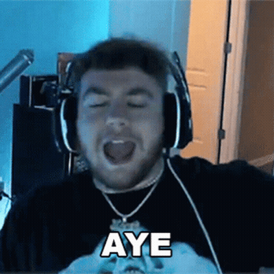 a man wearing headphones and a necklace is making a funny face and says aye .