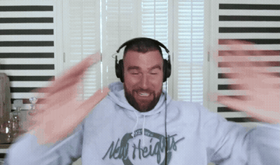 A Man Wearing Headphones And A New Heights Hoodie GIF