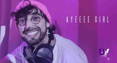 A Man Wearing Headphones And A Pink Hat Is Smiling In Front Of A Purple Background With The Words Ayeee Girl GIF