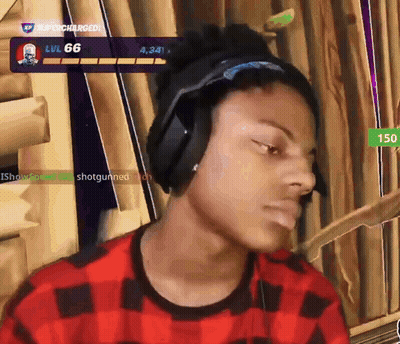A Man Wearing Headphones And A Plaid Shirt Is Playing A Video Game With The Number 66 On The Screen Behind Him GIF