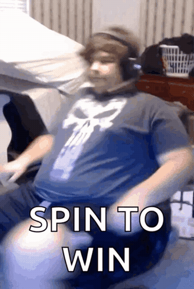 A Man Wearing Headphones And A Punisher Shirt Is Sitting On A Couch And Says Spin To Win GIF