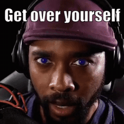 A Man Wearing Headphones And A Purple Hat Has The Words Get Over Yourself Written On His Face GIF